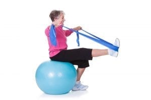 Woman going through exercise therapy on a yoga ball